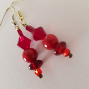 A punch of red simple dangle earrings with glass beads of varying colours of red and pink